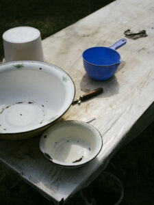 Several empty bowls stand on a table covered by a tarp.