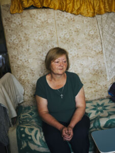 Larisa Pisarenko sitting on a blanket on a sofa.